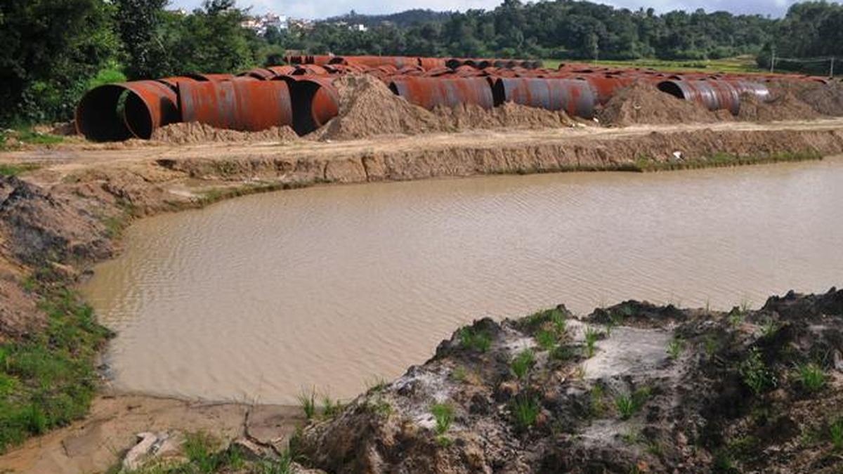 Massive water pipes laid out in rural landscape