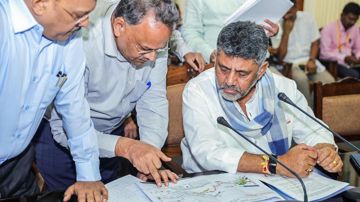 Elected officials reviewing layout plans